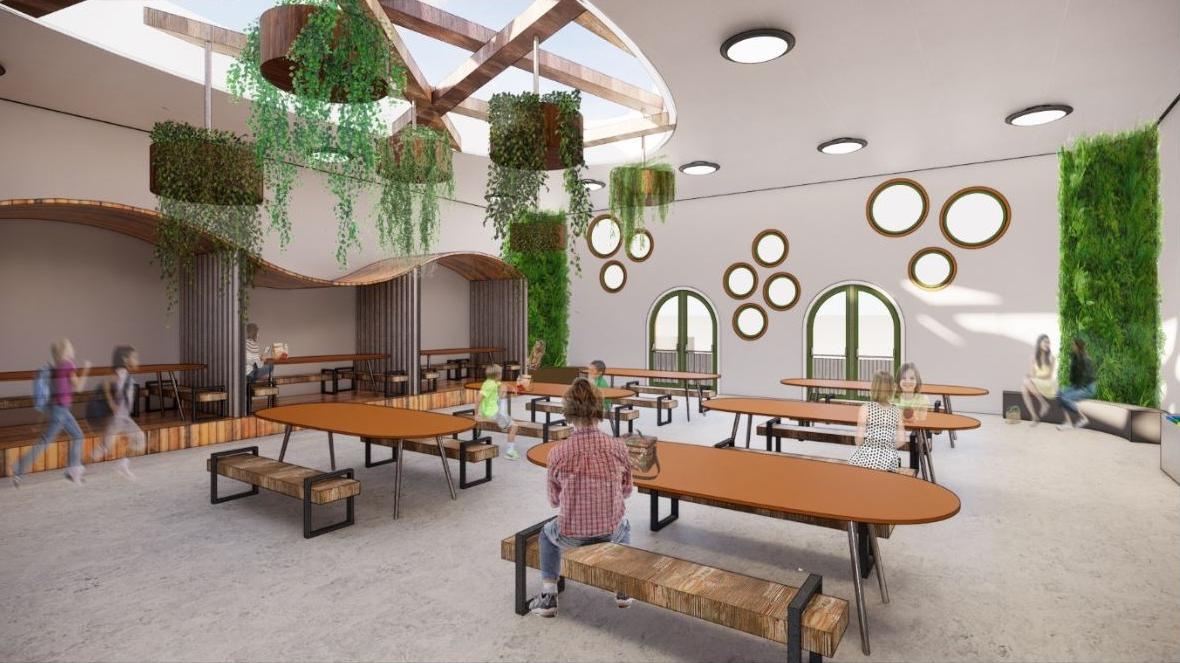A rendering of a school cafeteria with oval tables and hanging plants.